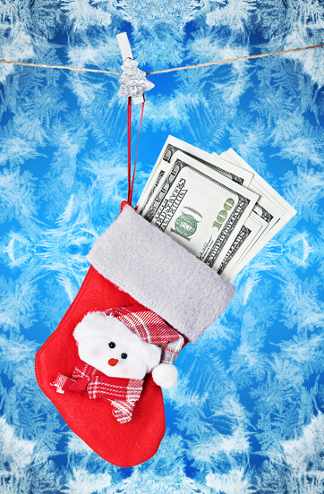 Christmas Stocking Stuffed with Money on background frosty glass